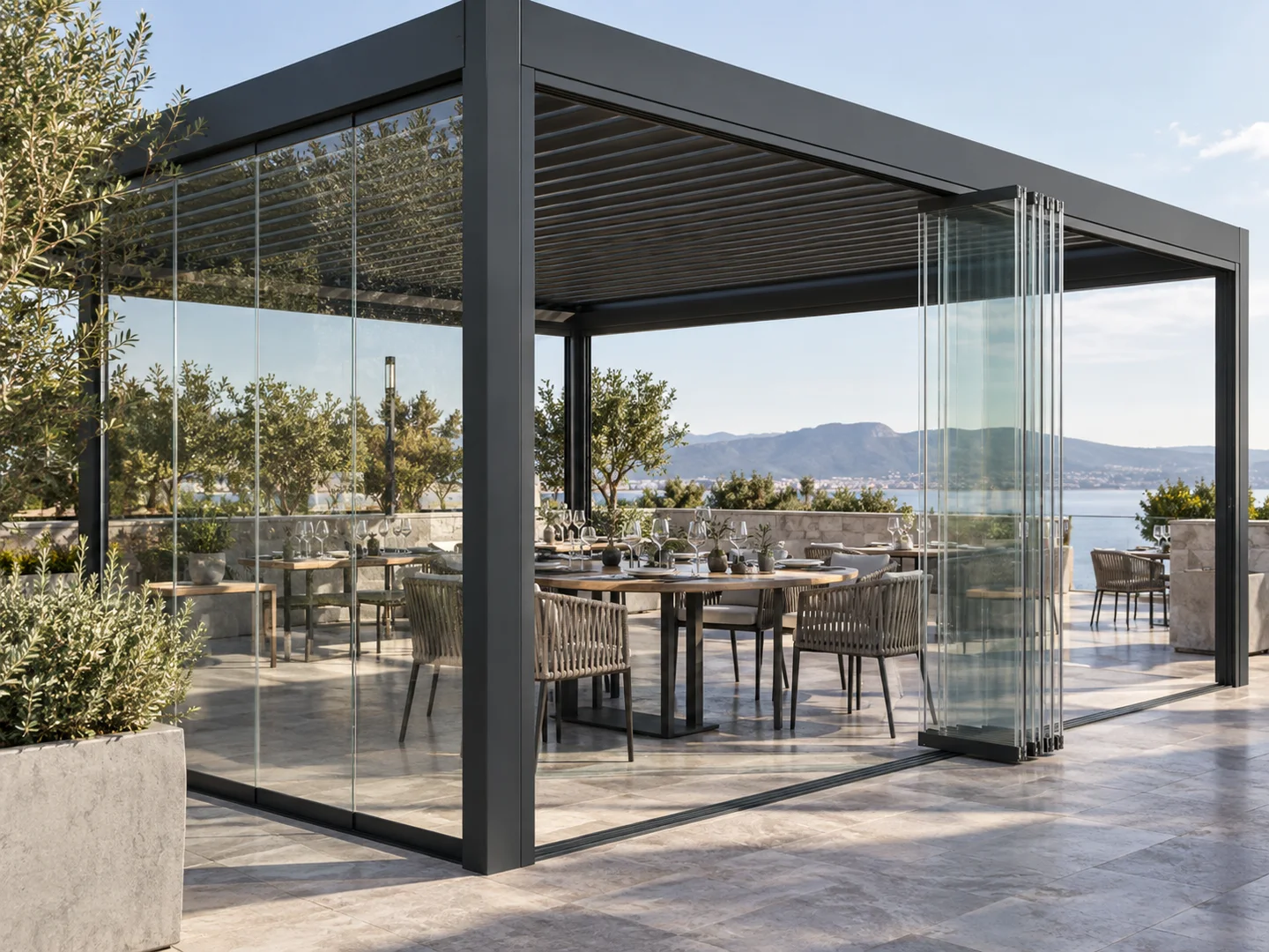 Sliding and folding glass panels installed around an aluminum pergola dining terrace