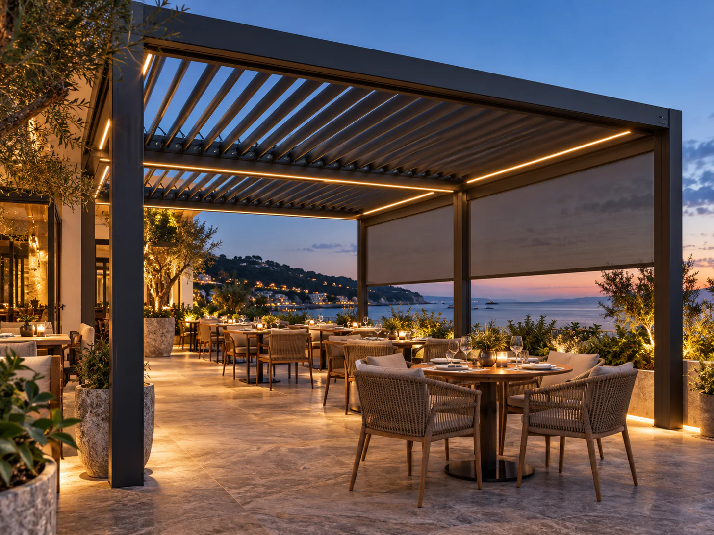 Motorized louvered pergola with ZIP screens above a restaurant dining terrace